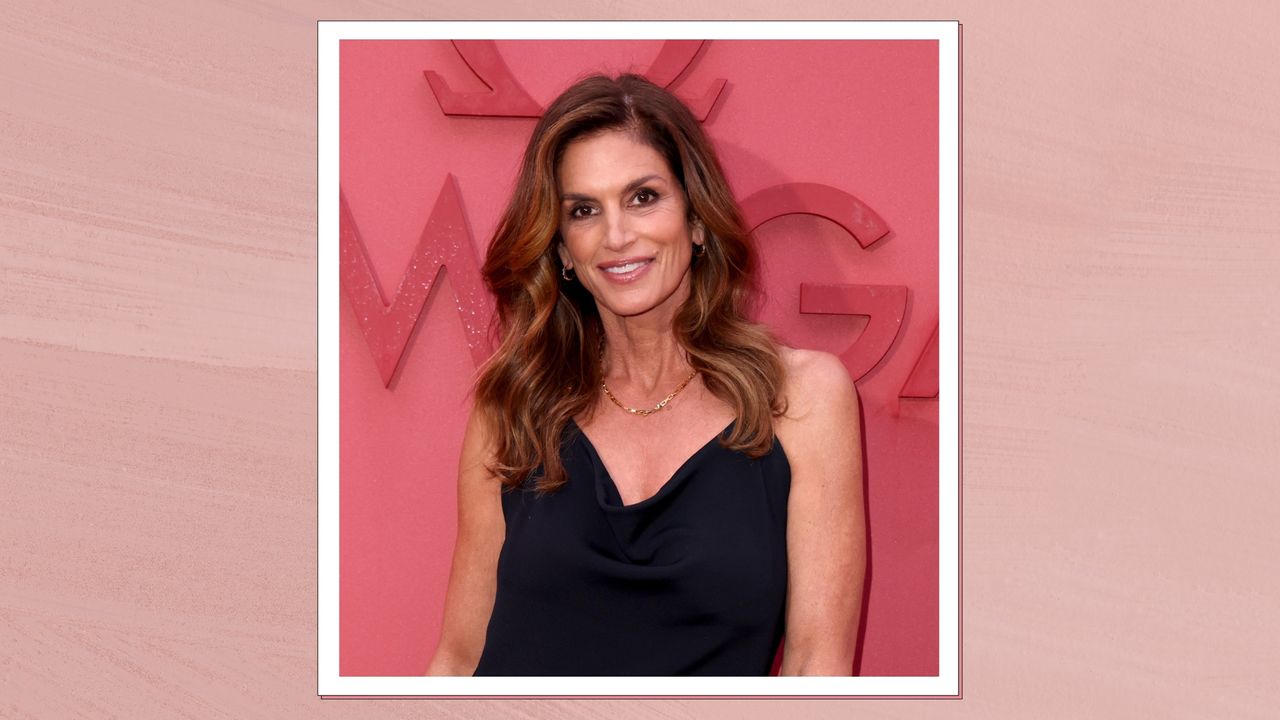 Omega Brand Ambassador Cindy Crawford is pictured with loose waves and wearing a black dress whilst attending the opening night of OMEGA House Paris 2024 on July 27, 2024 in Paris, France/ in a pink template