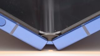 Samsung Galaxy Z Flip 7 in blue close up on the hinge and bending glass