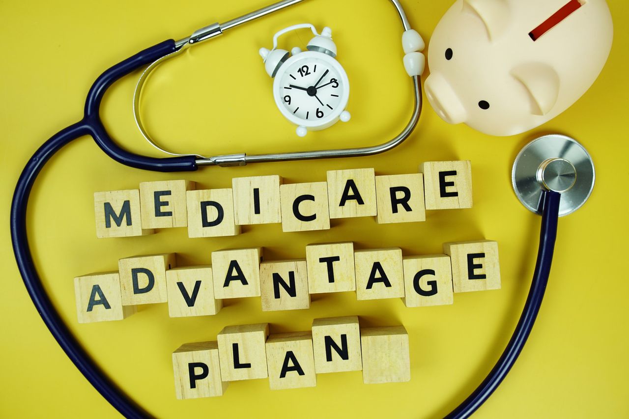 Medicare Advantage Plan with wooden blocks alphabet letters and stethoscope on yellow background