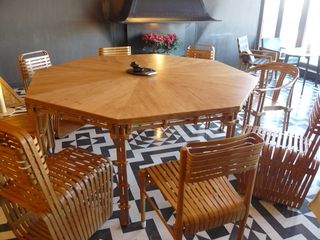 Octagonal bamboo table and chairs on a floor of black and white geometric tiles