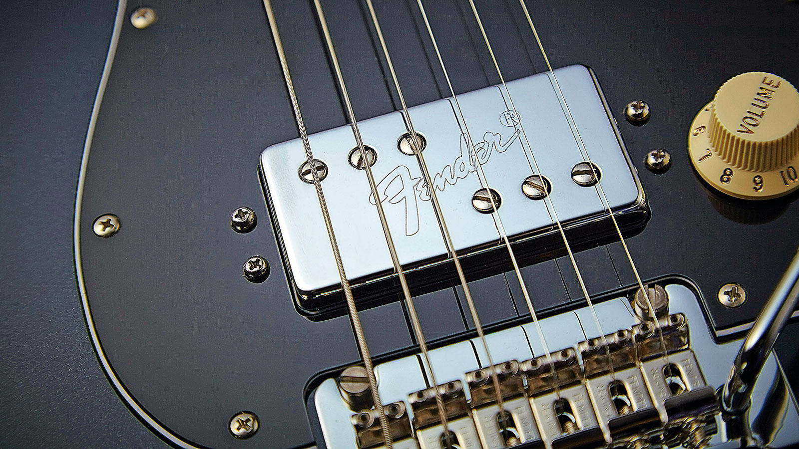 The Wide Range humbuckers with Fender logo, set against the nearly-black Mercedes Blue finish, ooze class