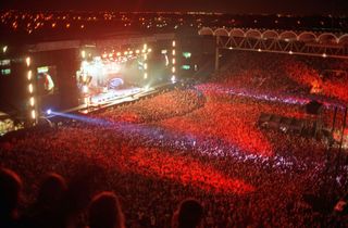 Oasis on stage at Manchester City's football ground, Maine Road