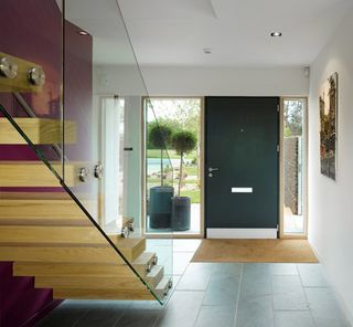 The hallway includes a cantilevered ash tread staircase