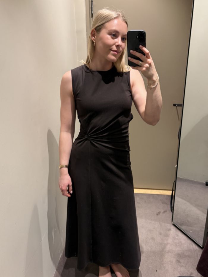 Woman wears brown twist-detail dress