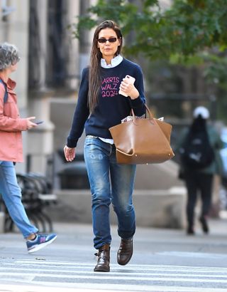 Katie Holmes wears a Kamala Harris for President sweater with skinny jeans while walking in Manhattan