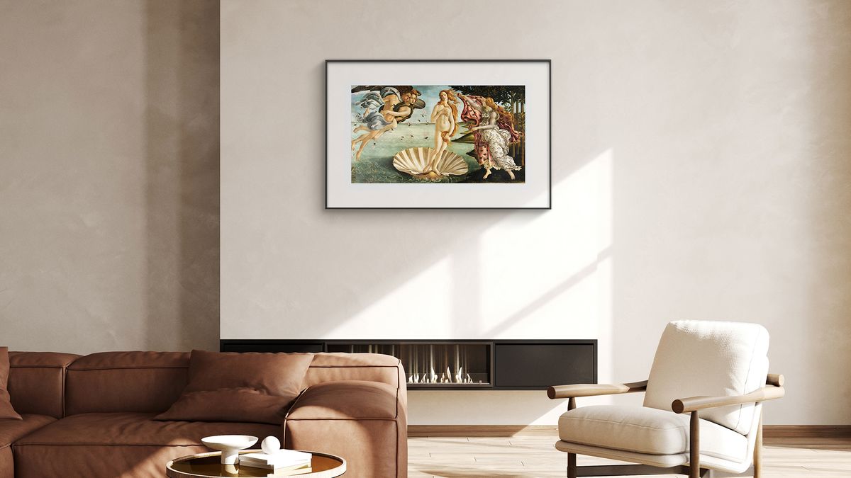 A PocketBook InkPoster e-ink digital picture frame is displayed in a living room