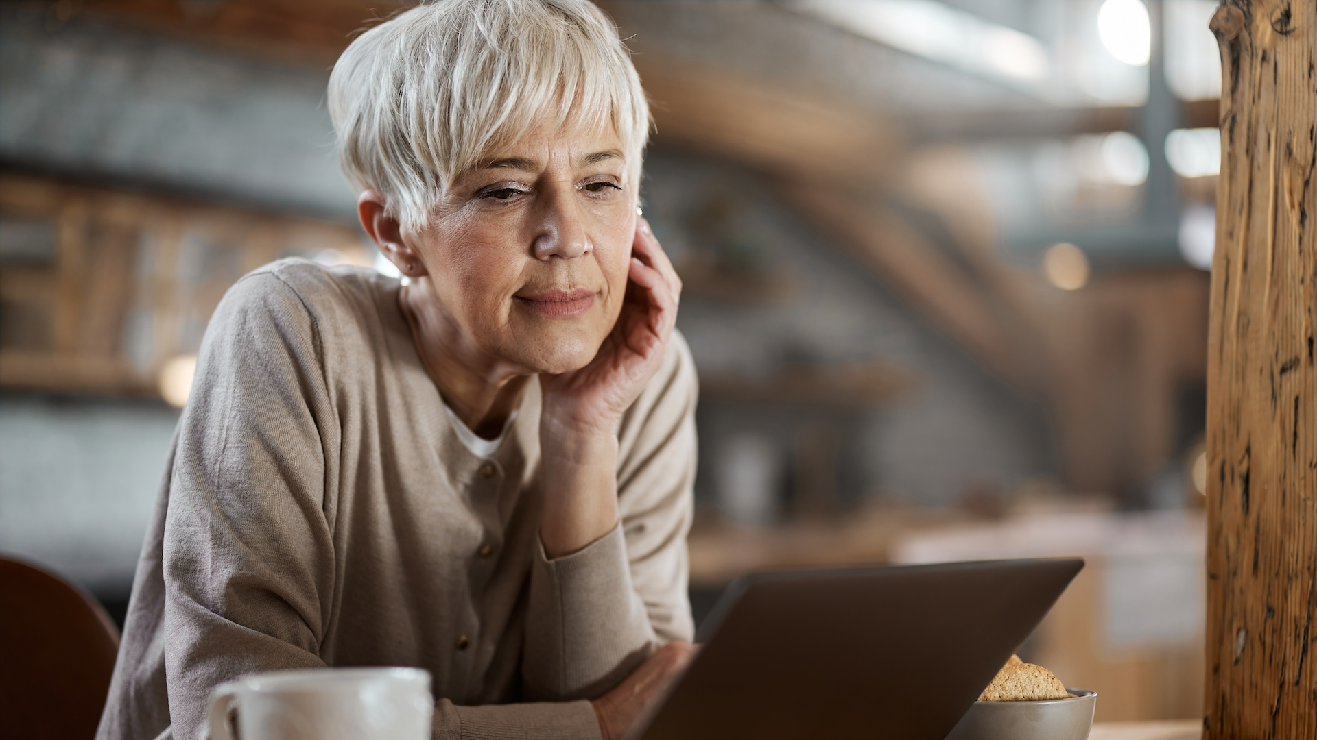 Woman looking at laptop in kitchen