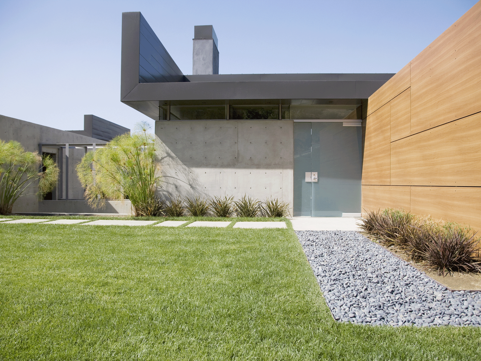 modern garden with grass, pavers and pebbles