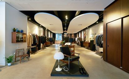The design collection laid out in different sections of the stores shop floor featuring white walls, black and white ceiling design and beige flooring