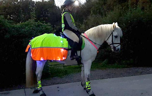 “This is me and my seven-year-old Connemara, Storm. We compete in all disciplines but endurance is our favourite. Keeping up our fitness in the winter around work is hard so I have done some creative sewing and made him visible for the half light and dark evenings. I also wear a head torch over my riding helmet to help us be seen” — Hannah Sedgwick