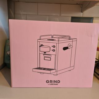 The Grind One Pod coffee maker in the box