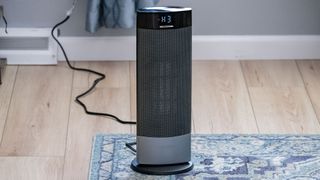 Lasko Ellipse CT18950 Tower Space Heater in a person's room placed on a rug