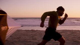 Jonathan Majors running on the beach in Creed III