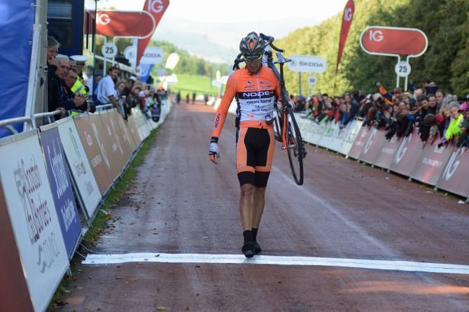 Roman van Uden crosses the line on foot after crashing