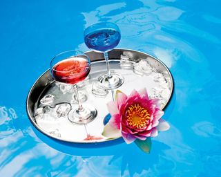 pool party ideas tray of drinks floating in pool