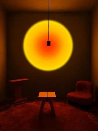 Dark room with a bright yellow hanging light