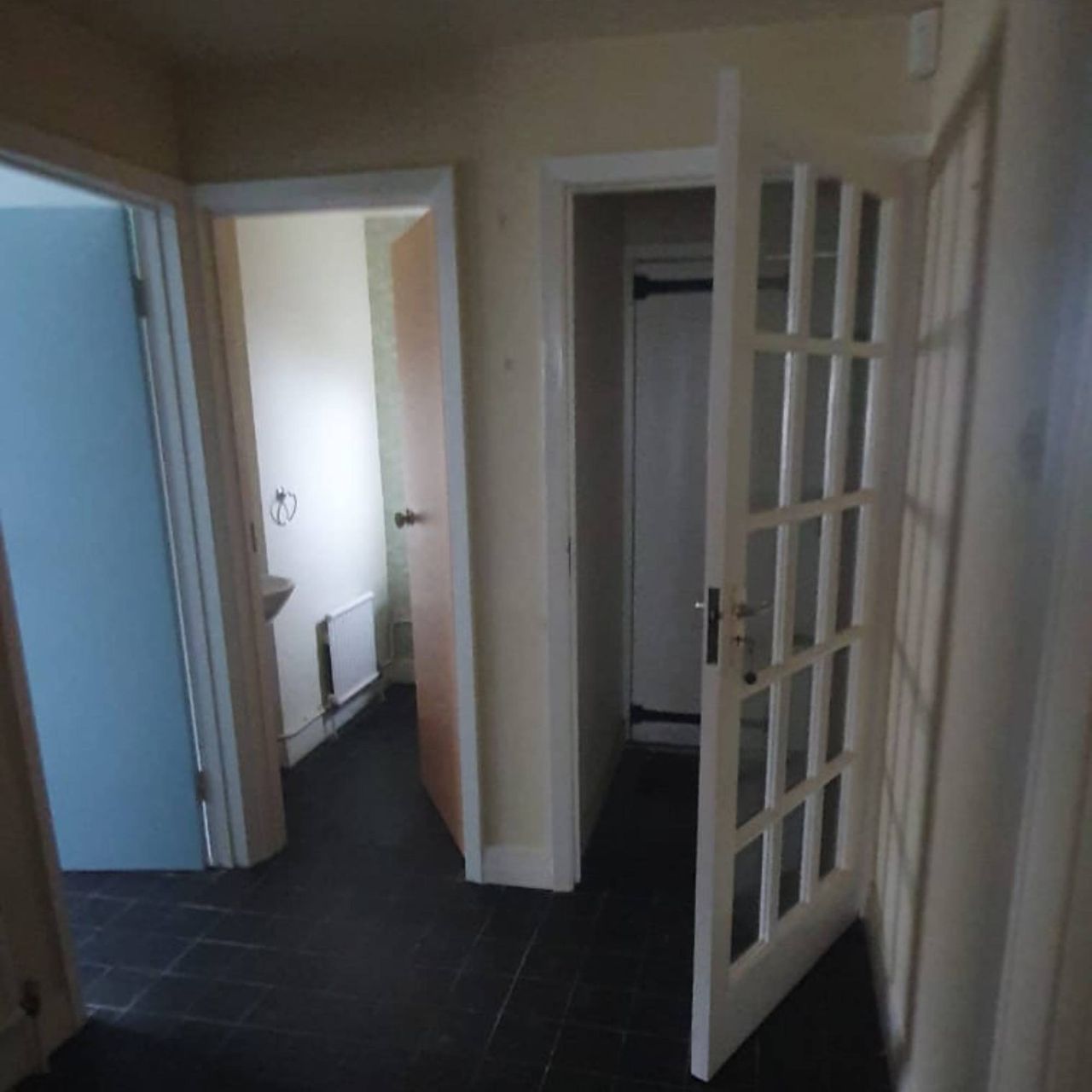 dark porch area with black floor and open glass door
