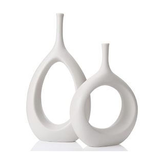 white loop shaped vase with space in middle
