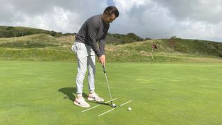 Joe Ferguson using alignment sticks for putting