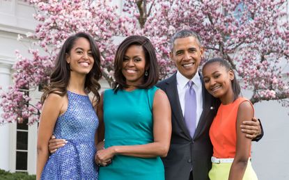 Obama family underneath a cherry blossom tree