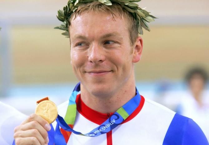 hris Hoy celebrates on the podium at the end of the men's 1 km time trial final at the Athens velodrome