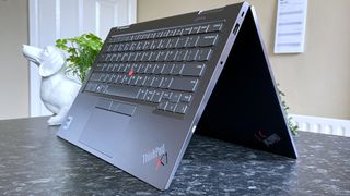 Lenovo ThinkPad X1 Yoga (Gen 8) folded outwards in tablet mode, displaying they now-inactive keyboard and touchpad