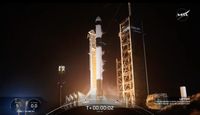 a black-and-white spacex falcon 9 rocket launches into a night sky.