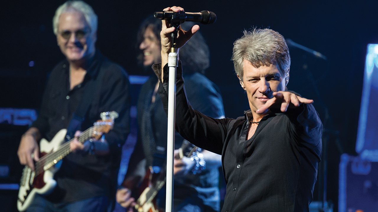 Jon Bon Jovi on stage pointing at the crowd