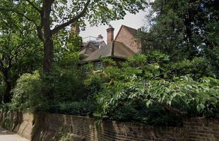 An exterior view of Robbie Williams' red brick historic home in Holland Park