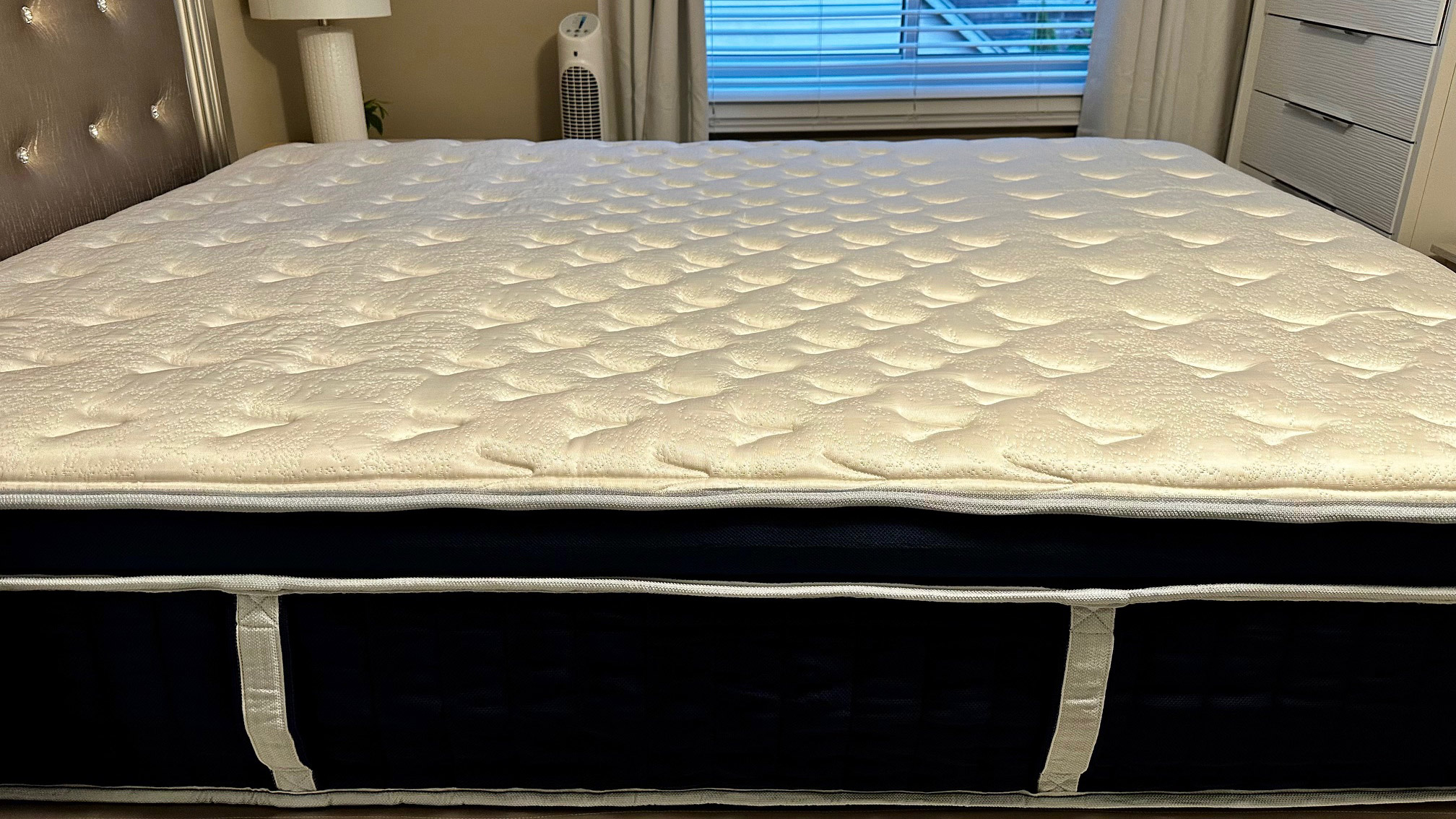 Side on view of the Glacier Apex Hybrid mattress in a bedroom