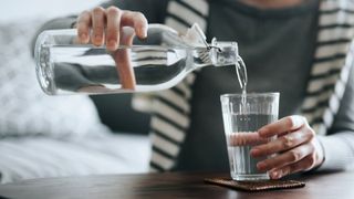 Woman pouring water into glass