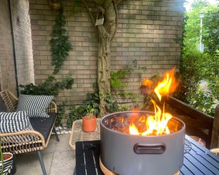 BergHOFF Tabletop BBQ alight on table in garden underneath pergola