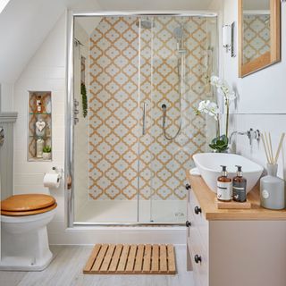 bathroom with yellow tiles and glass sliding door