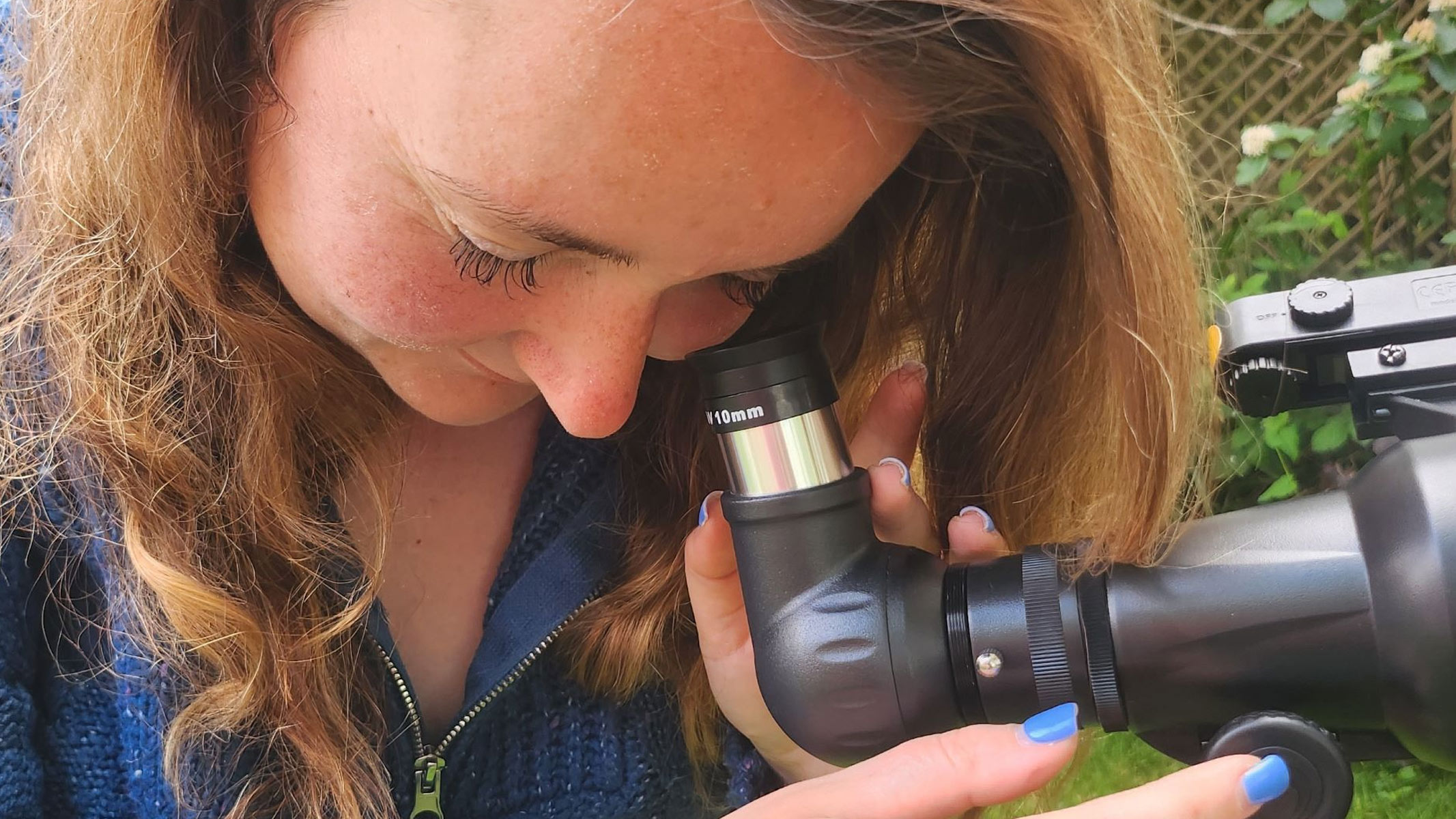 Our reviewer looking through the eyepiece of the Celestron StarSense Explorer LT 70AZ.