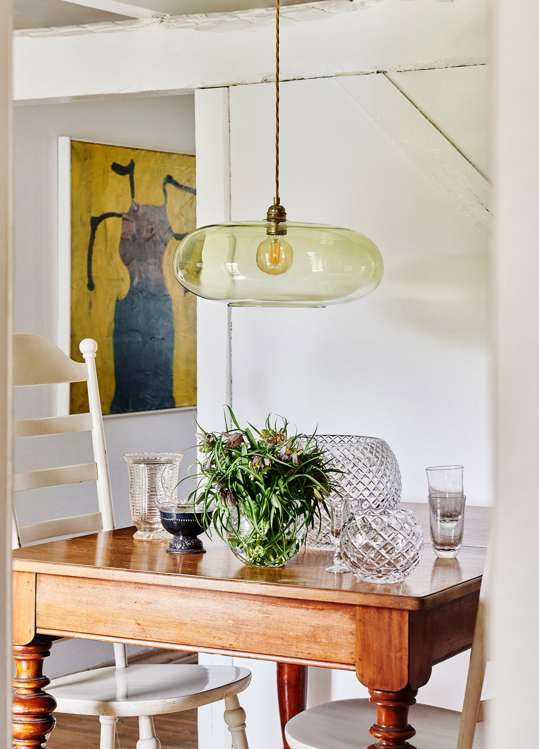tinted glass pendant light over dining table
