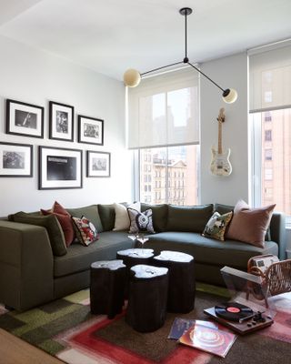 A living area with a dark grey sofa and wooden coffee table