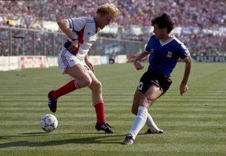 Robert Prosinecki of Yugoslavia tries to dribble past Argentina's Juan Simon at the 1990 World Cup in Italy.