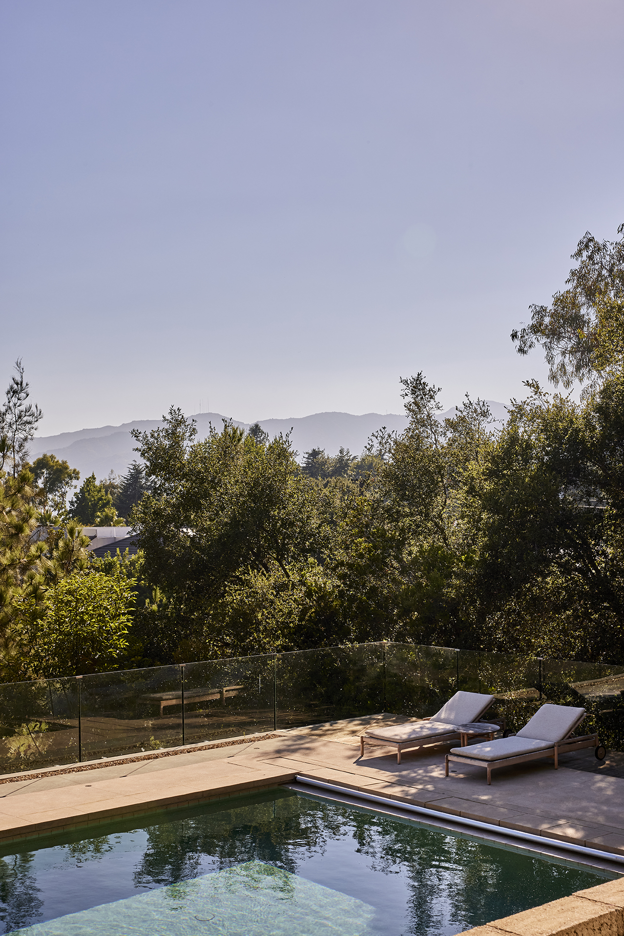 A tranquil poolside sanctuary overlooking the Los Angeles foothills, where expansive views and understated luxury define the living experience.