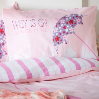 bedding with pink colour and pillow