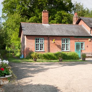 old rectory cottage with red brick walls and grey sloping roofs