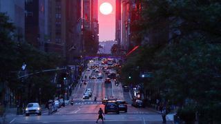 The sun sets along 42nd Street in a Manhattanhenge-like sunset on July 5, 2021.