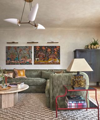 eclectic living room with large soft green sofa and statement accessories