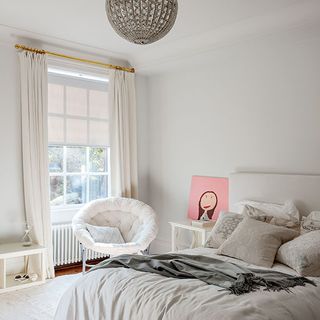 childrens room with white chair and wall