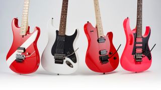 Four electric guitars, including a Squier Contemporary Stratocaster HH FR, on a white background