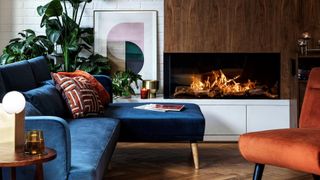 Contemporary living room with wood panel walls and modern fireplace with retro-inspired decor to suppoert interior design trends 2022 retro revival