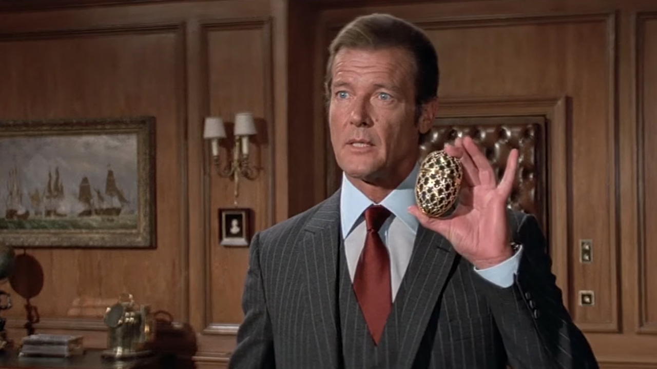 Roger Moore as James Bond holding the egg in Octopussy.