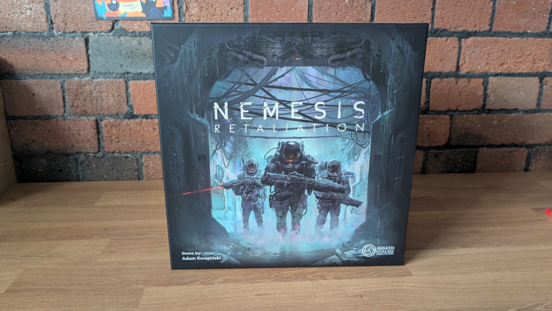 Nemesis: Retaliation box against a brick background