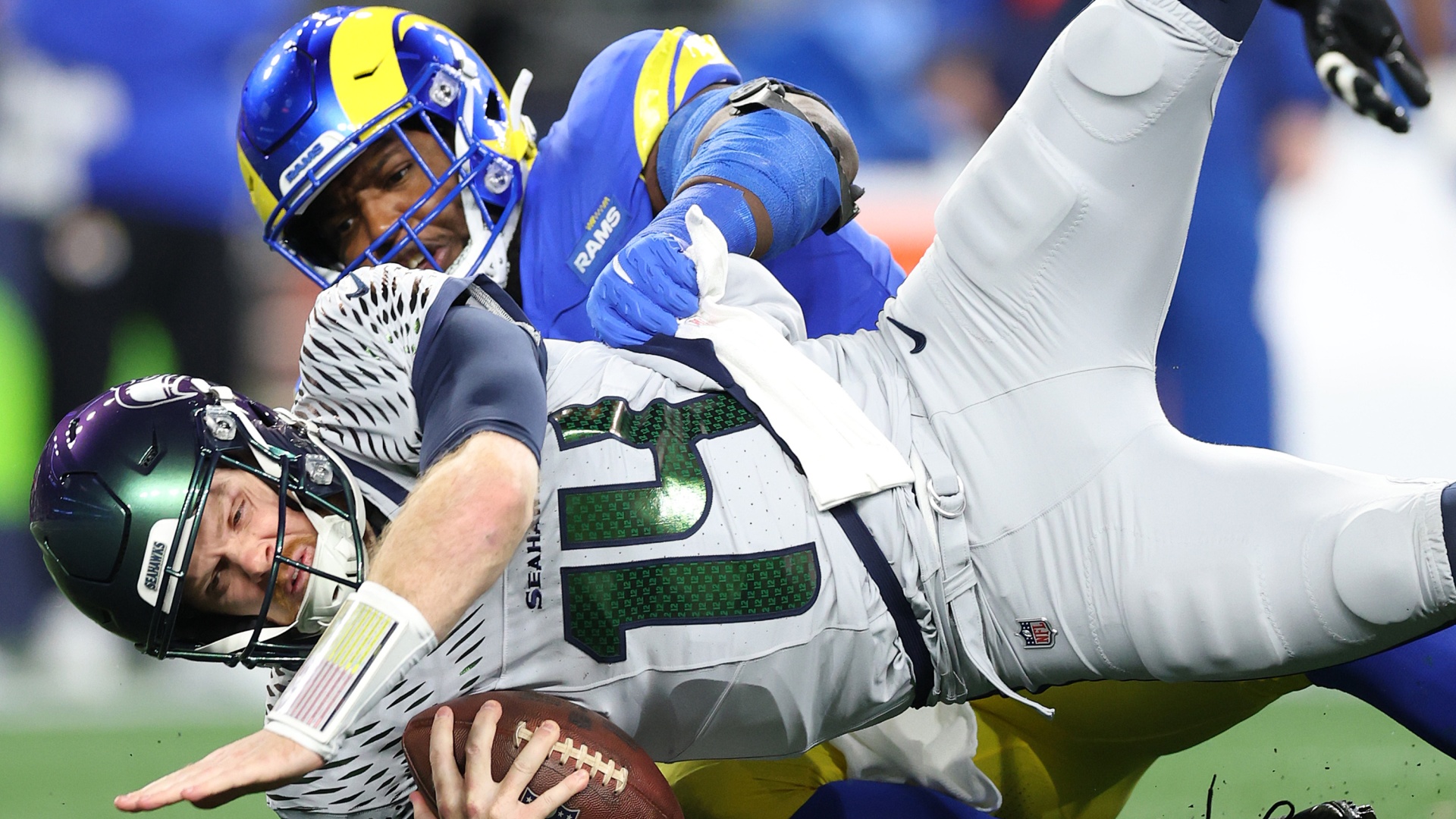 Kobie Turner of the Los Angeles Rams sacking Sam Darnold of the Seattle Seahawks