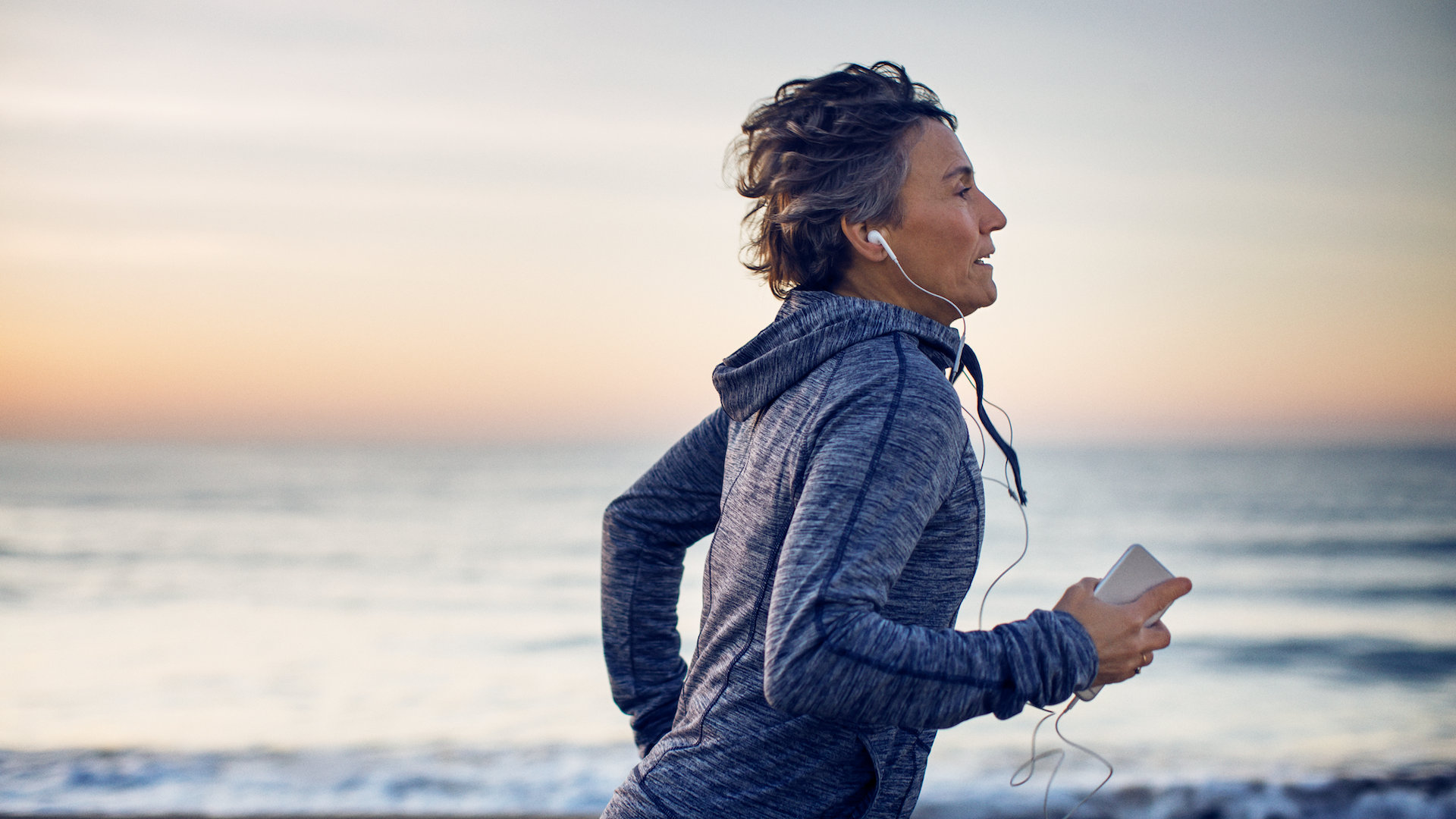 Woman running outdoors by sea