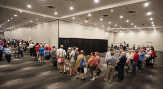World Stamp Show attendees lined up for scientist autographs after the presentation of the new "Pluto Explored" and "Views of Our Planet" stamps at the World Stamp Show in New York on May 31, 2016.